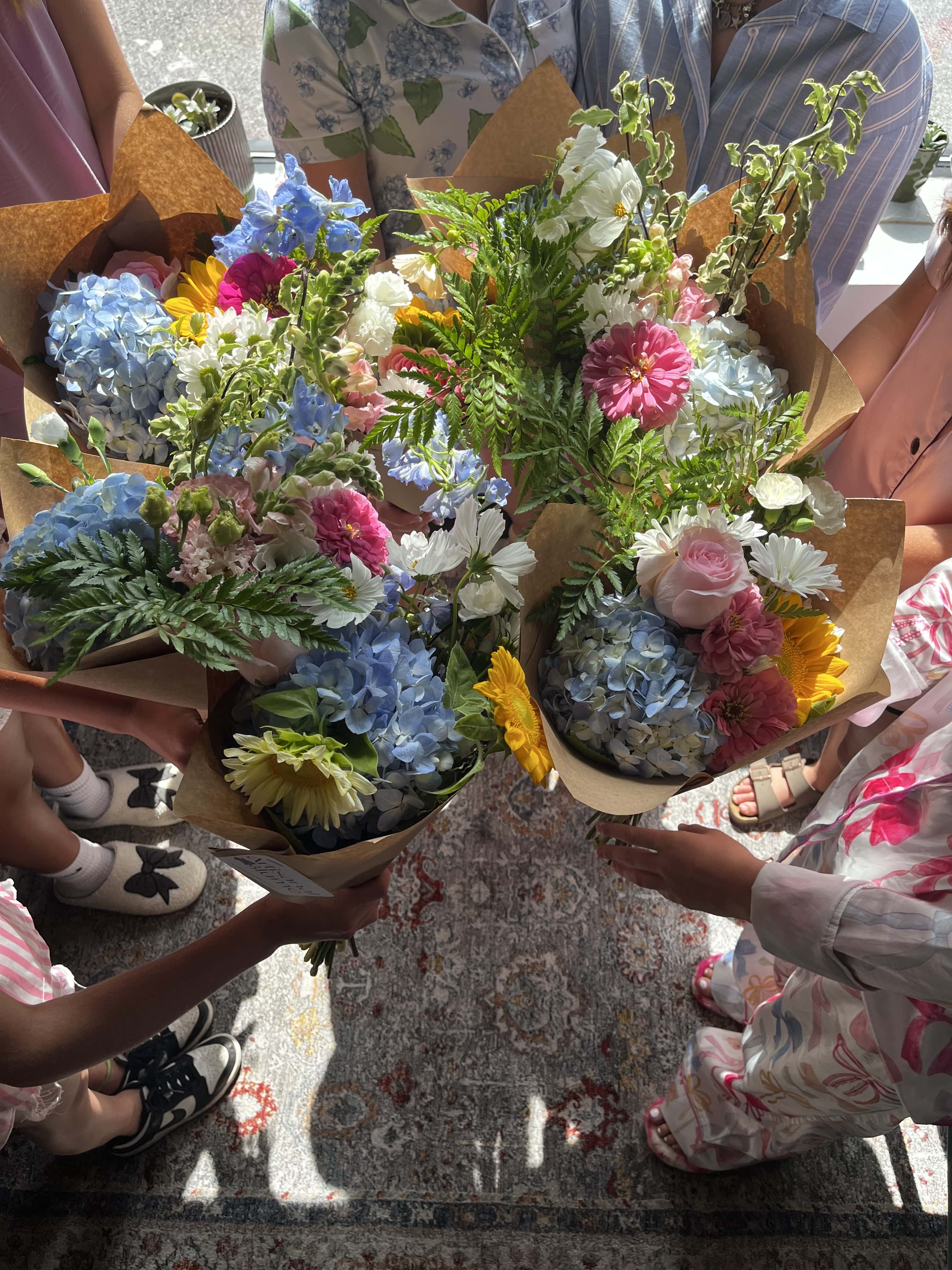 A group of partygoers with fresh floral arrangements